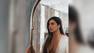 Priyanka Chopra admiring her dress one more time before taking it off for you